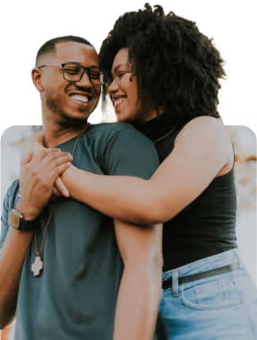 A happy couple share a hug.