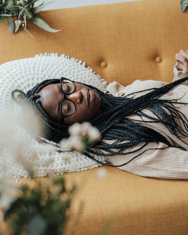 woman relaxing on her couch