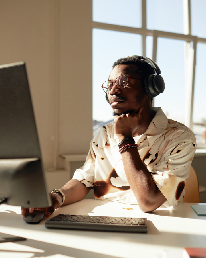 A black man working on his laptop