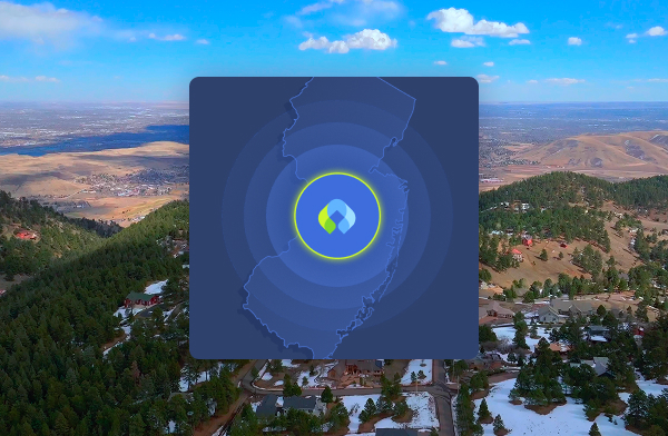 An aerial view of rolling hills and patchwork farmland, centered with a blue map overlay. The overlay features concentric circles radiating from a location in California with the Canopy logo centered within it.