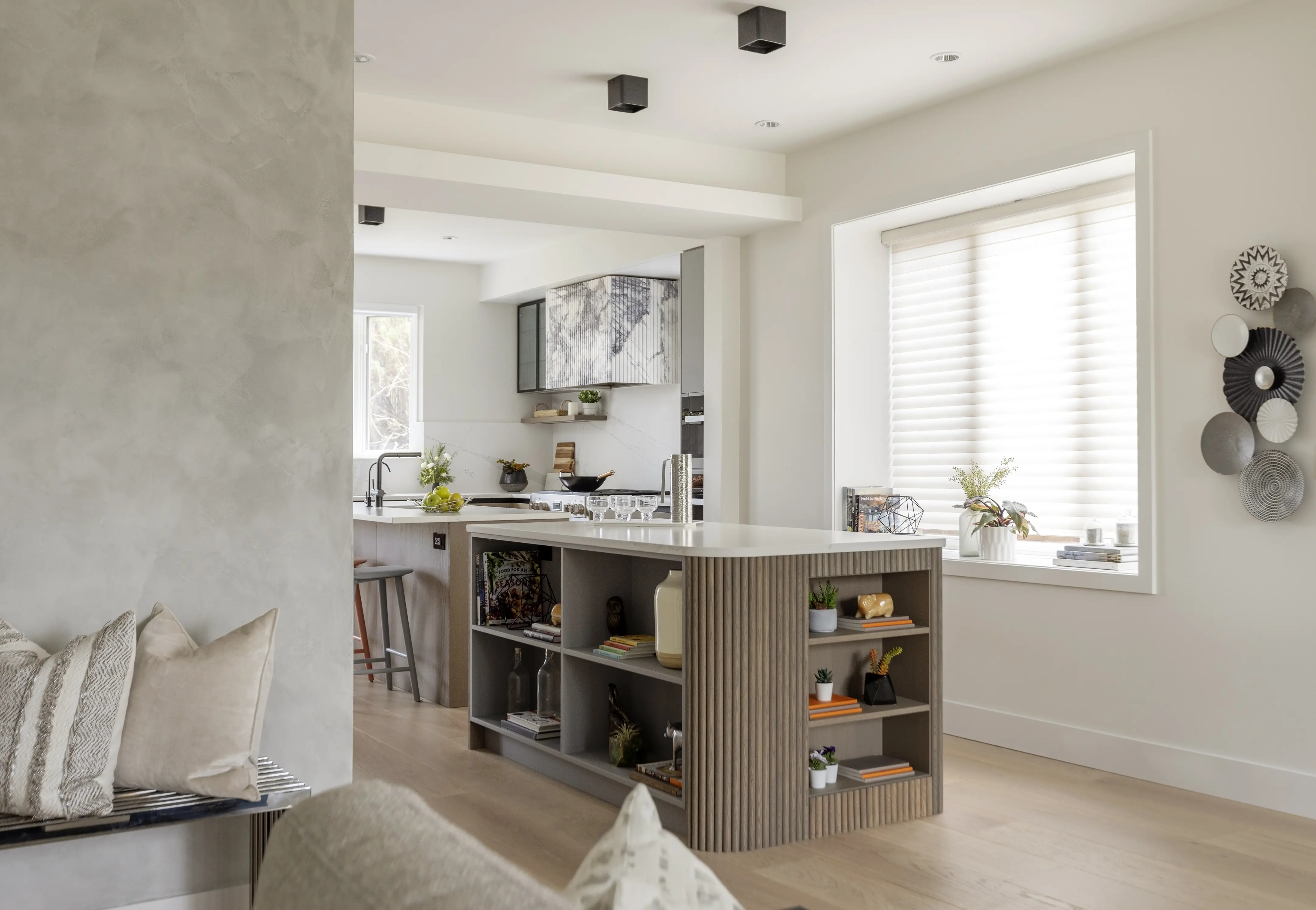 modern kitchen with rounded islands and storage inside. walnut cabinets with white stone countertops