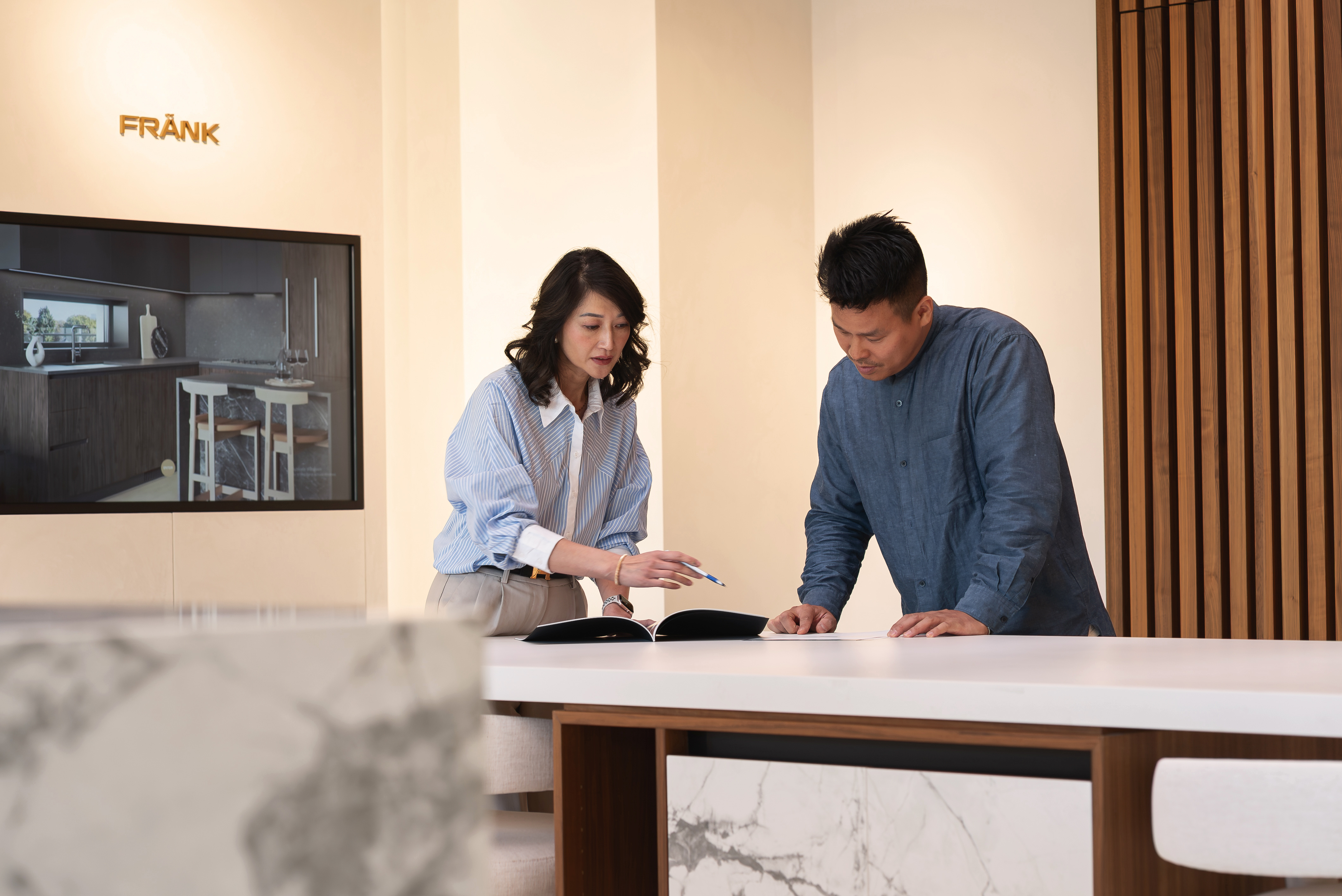 Two interior designers discussing plans on a table