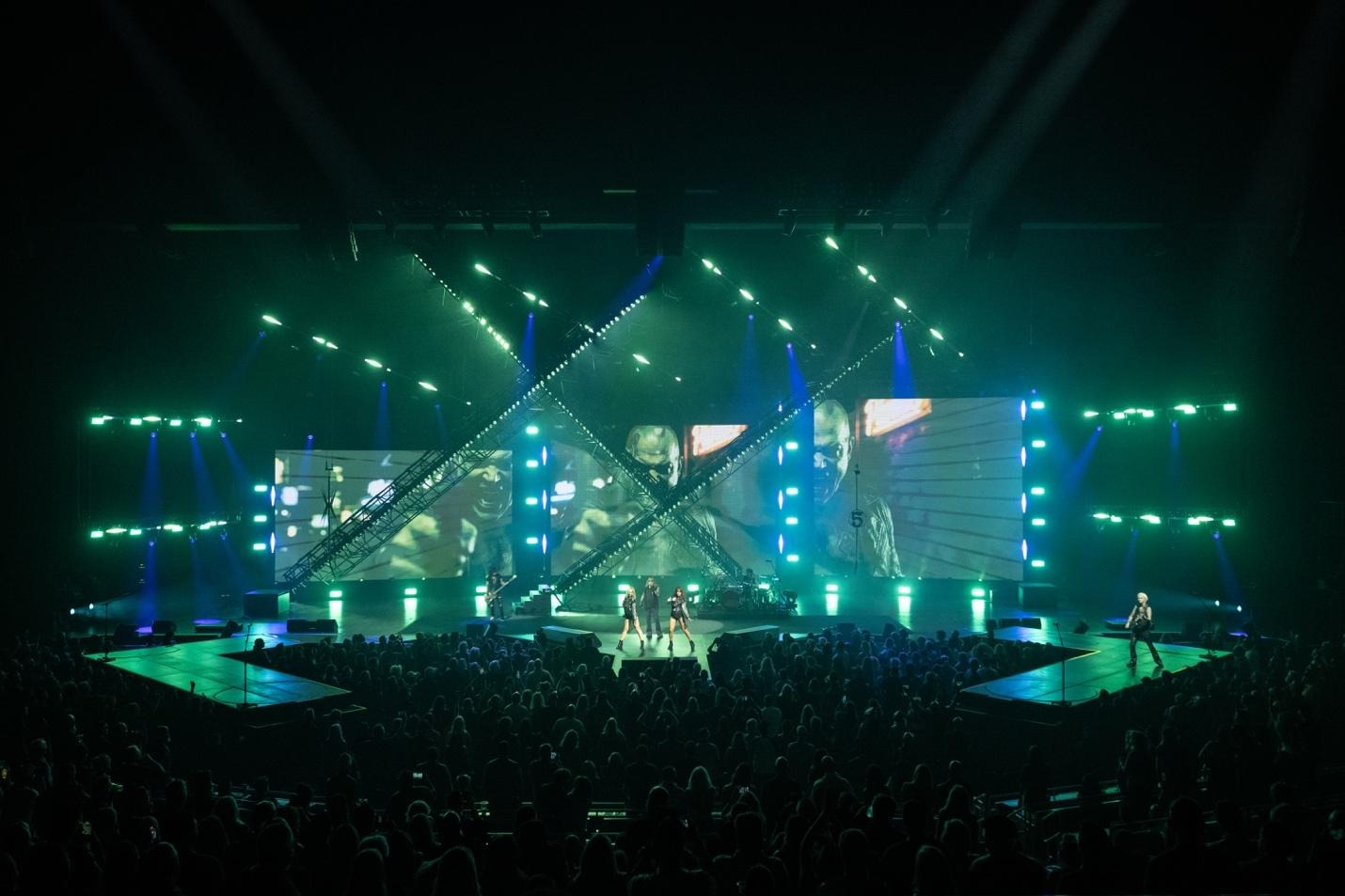 A group of people on a stage with lightsAI-generated content may be incorrect.