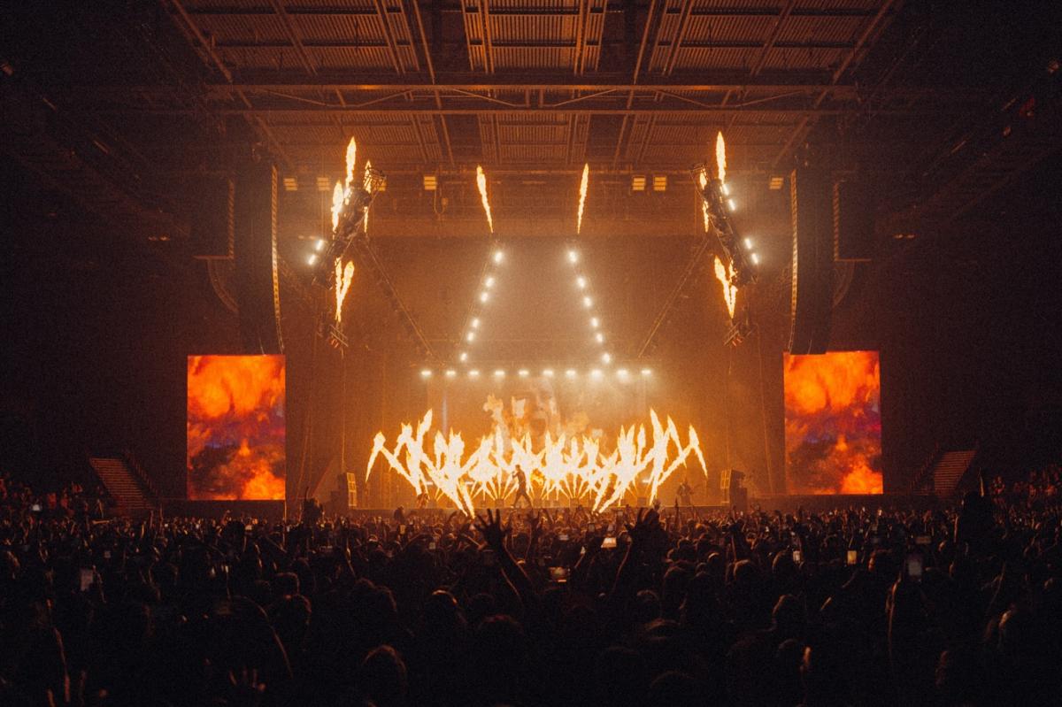 Falling in Reverse performing on stage at their concert featuring CHAUVET.