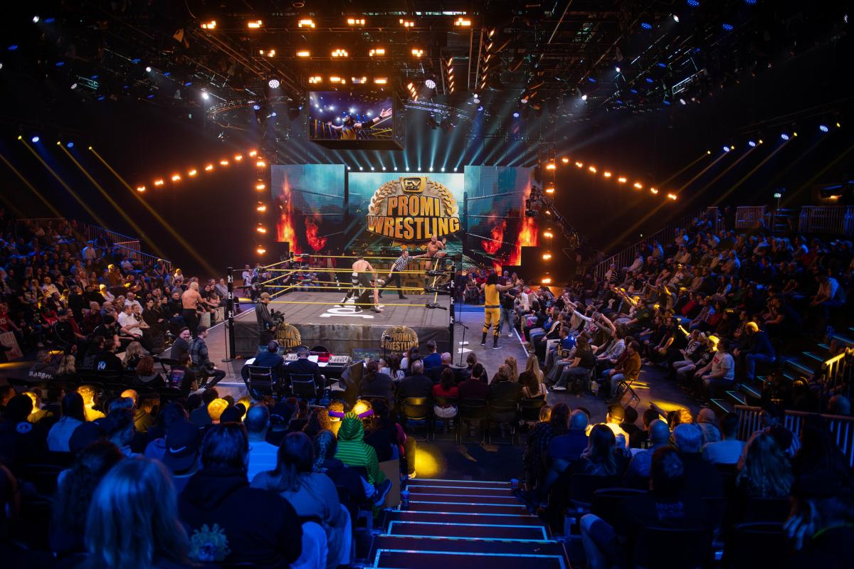 Promi Wrestling ring with a crowd in attendance watching two wrestlers in the ring.