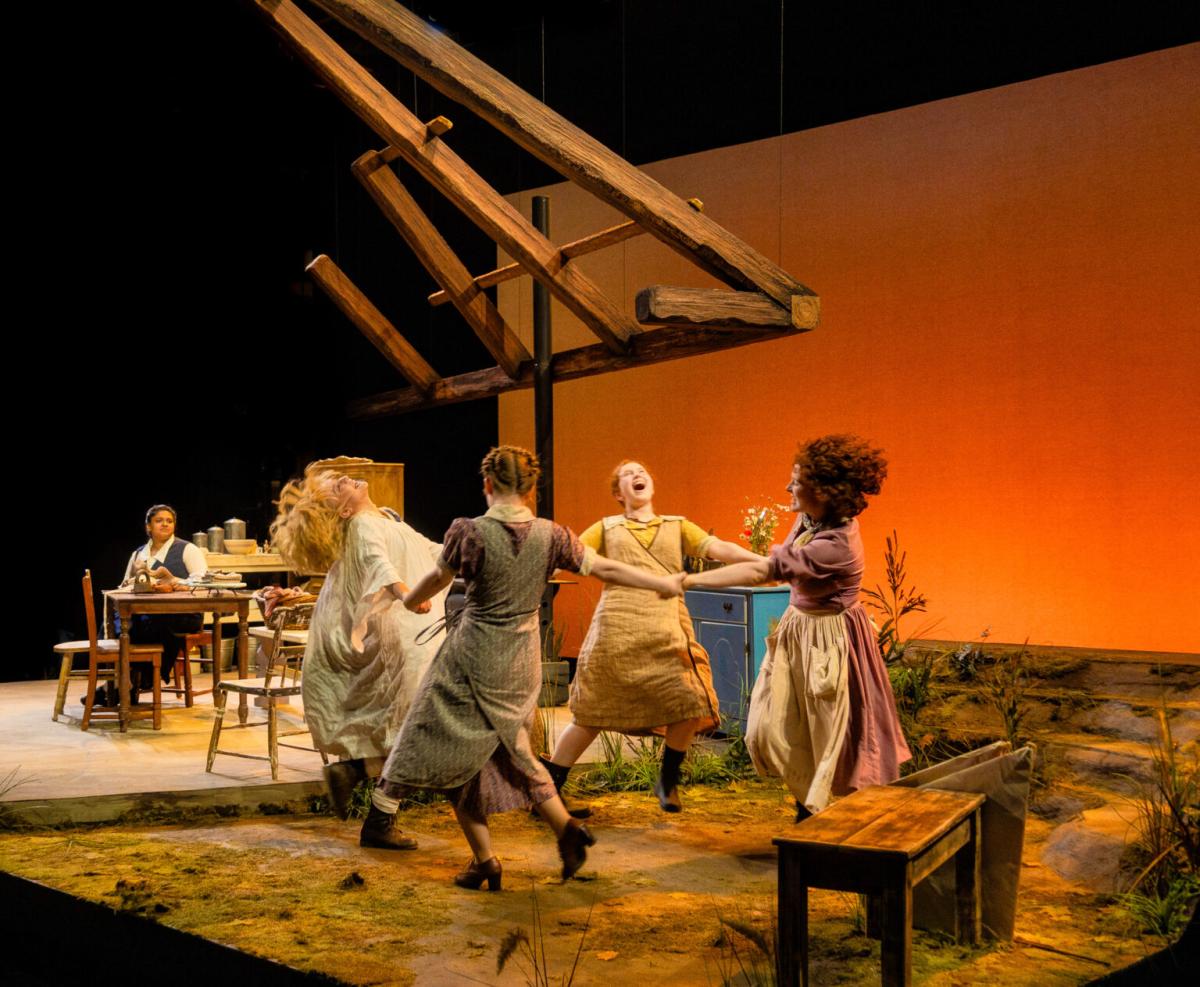 production shot of Dancing at Lughnasa. 4 people onstage holding hands in a circle.