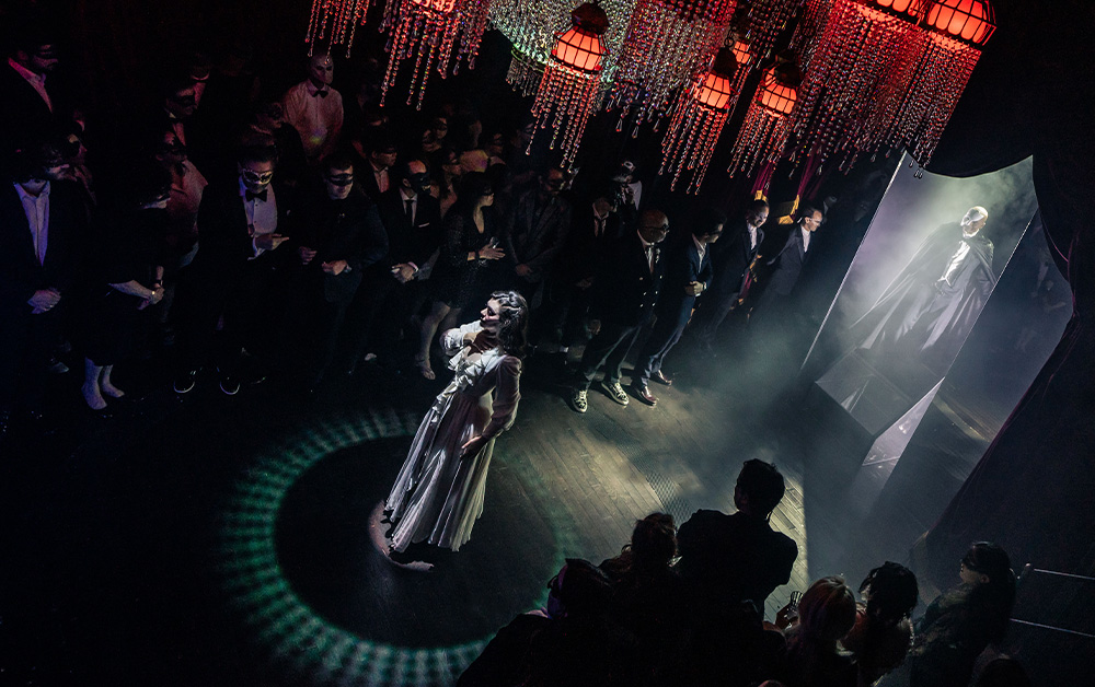 A person performing on a stage with a crowd of peopleAI-generated content may be incorrect.