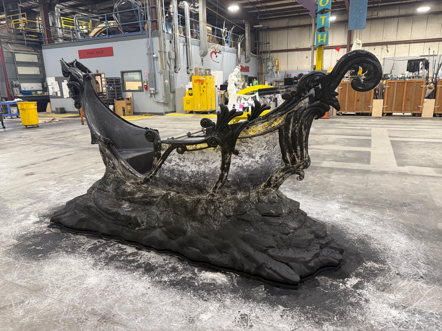 A sculpture of a sleigh in a factoryAI-generated content may be incorrect.