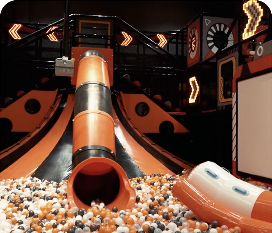 slide exiting into bin of balls