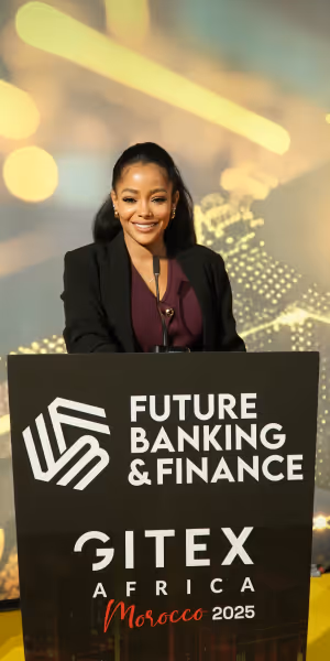 Smiling woman standing behind a podium with Future Banking & Finance and GITEX Africa Morocco 2025 branding.