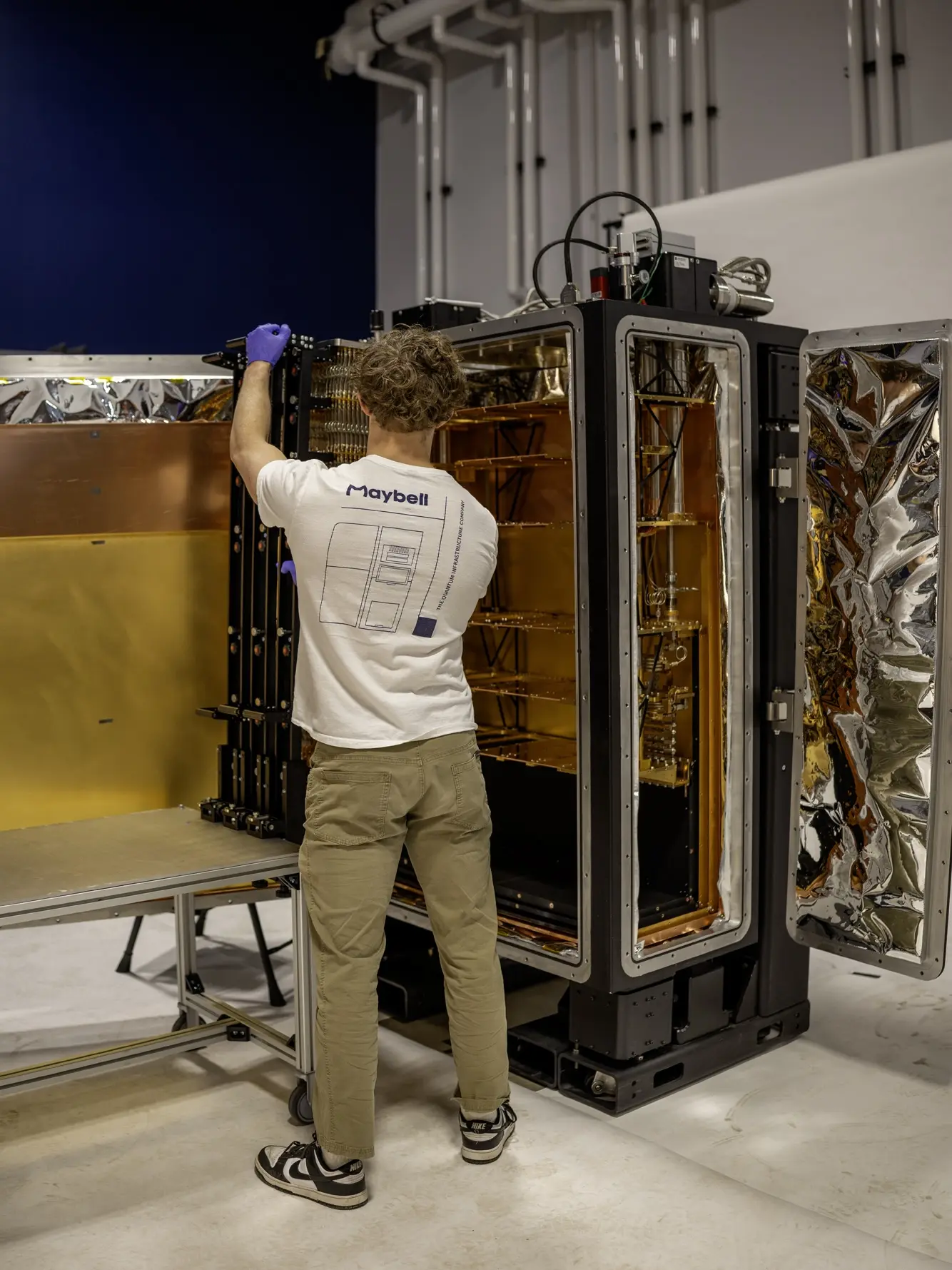 Technician adjusting wiring inside Maybell Big Fridge dil fridge