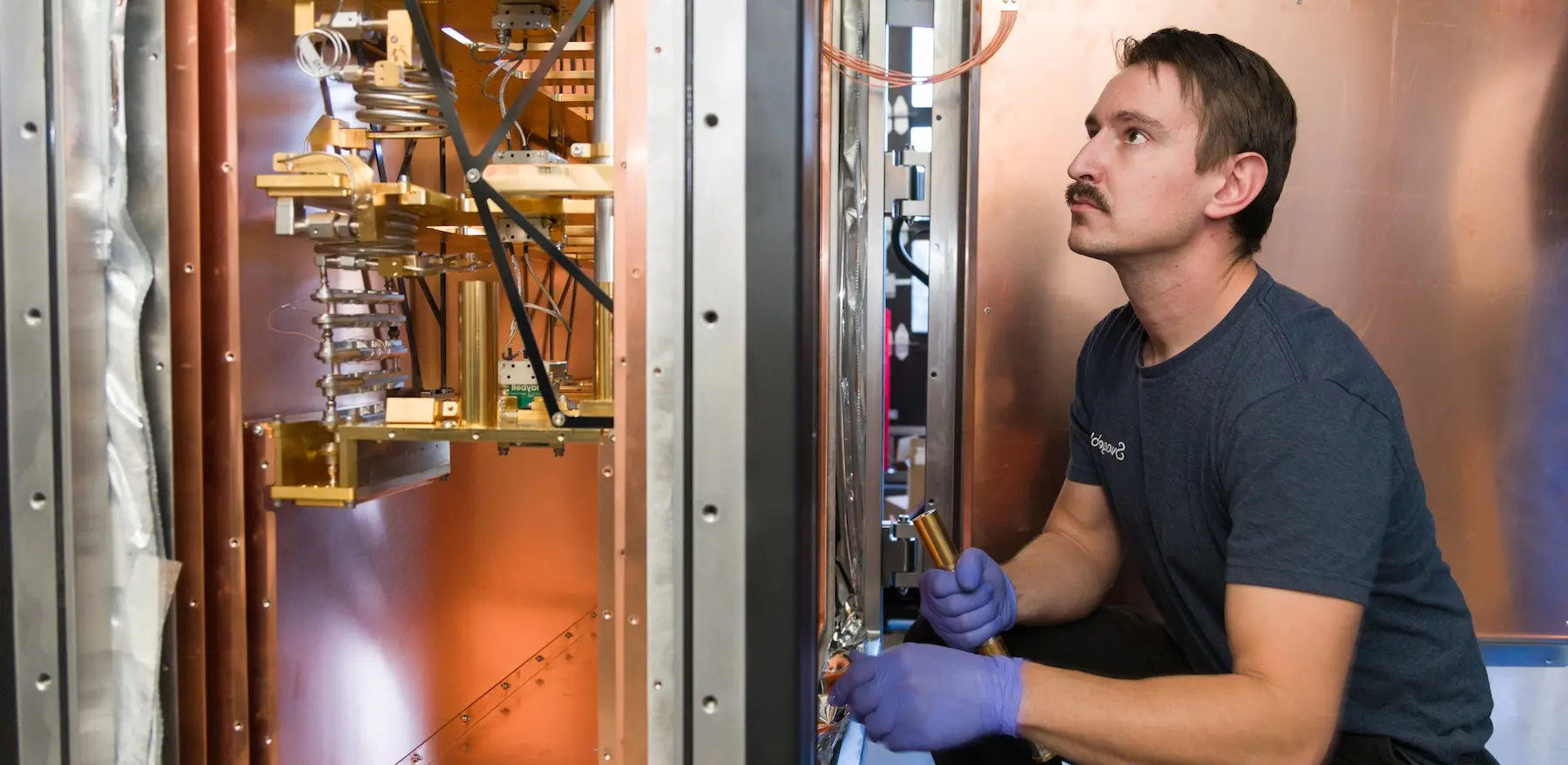 A Maybell engineer servicing a dilution refrigerator