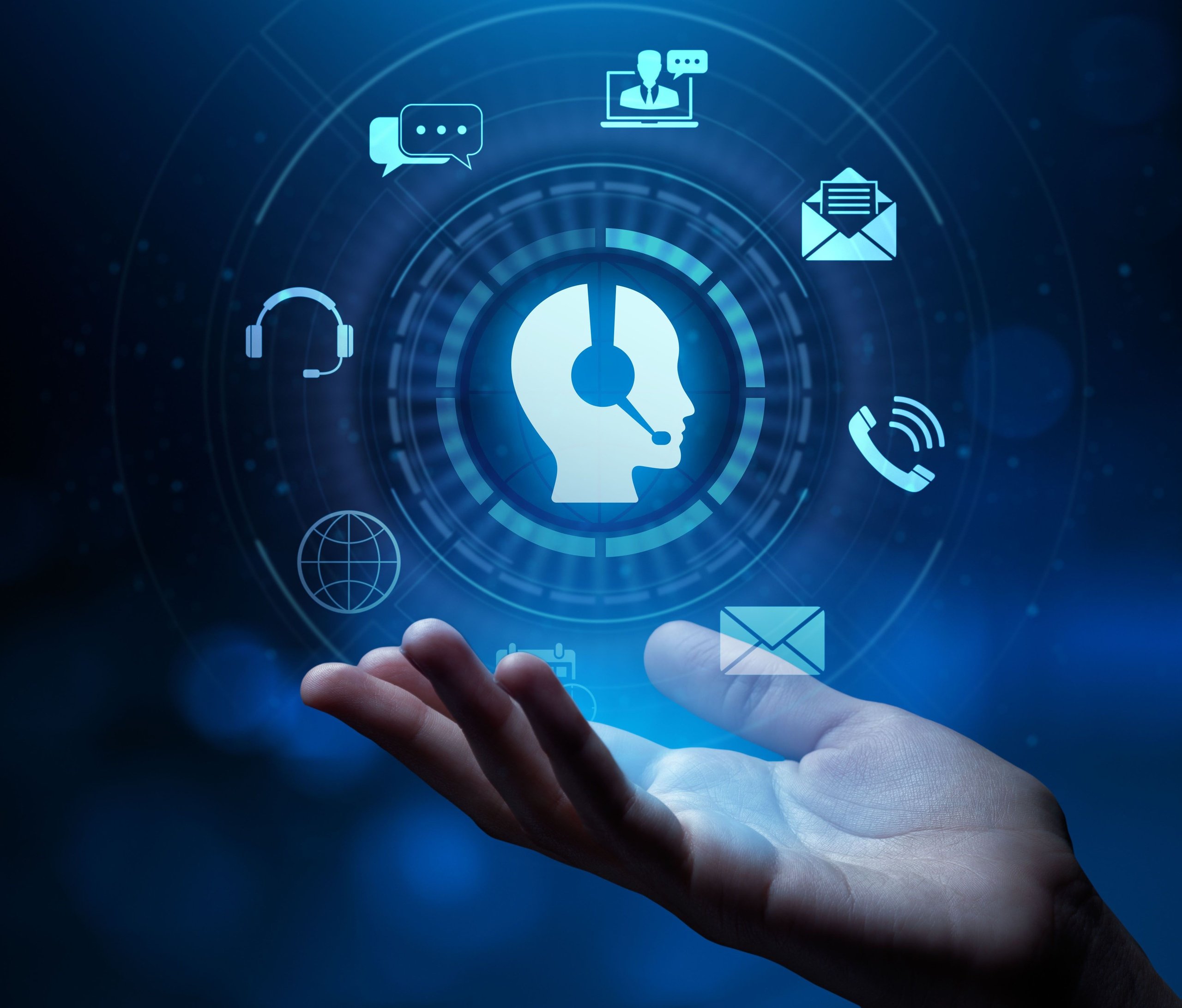 Hand with floating blue icons representing customer service communication, including headset, chat bubbles, phone, and email.
