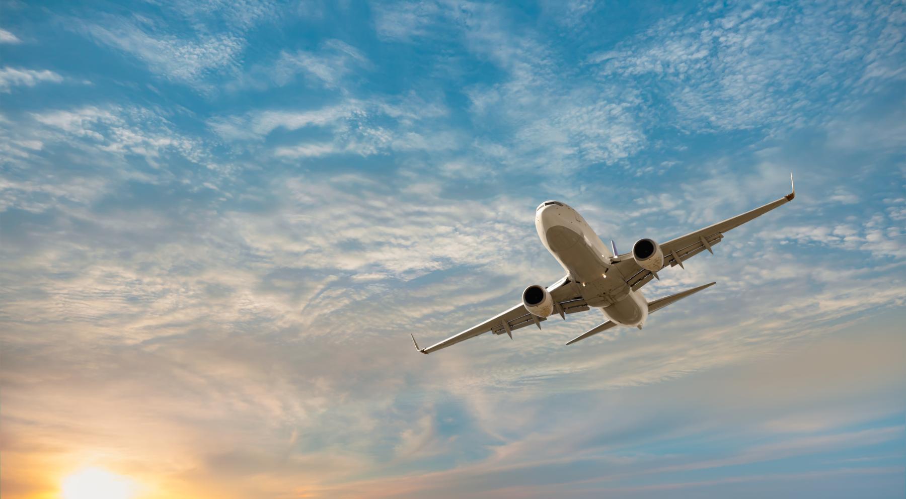 Large plane soaring through a blue sky