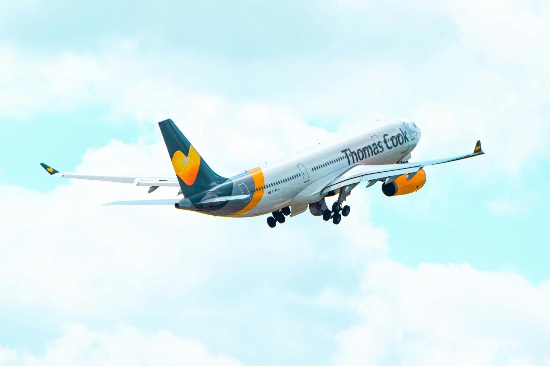Thomas cook branded plane flying through the sky