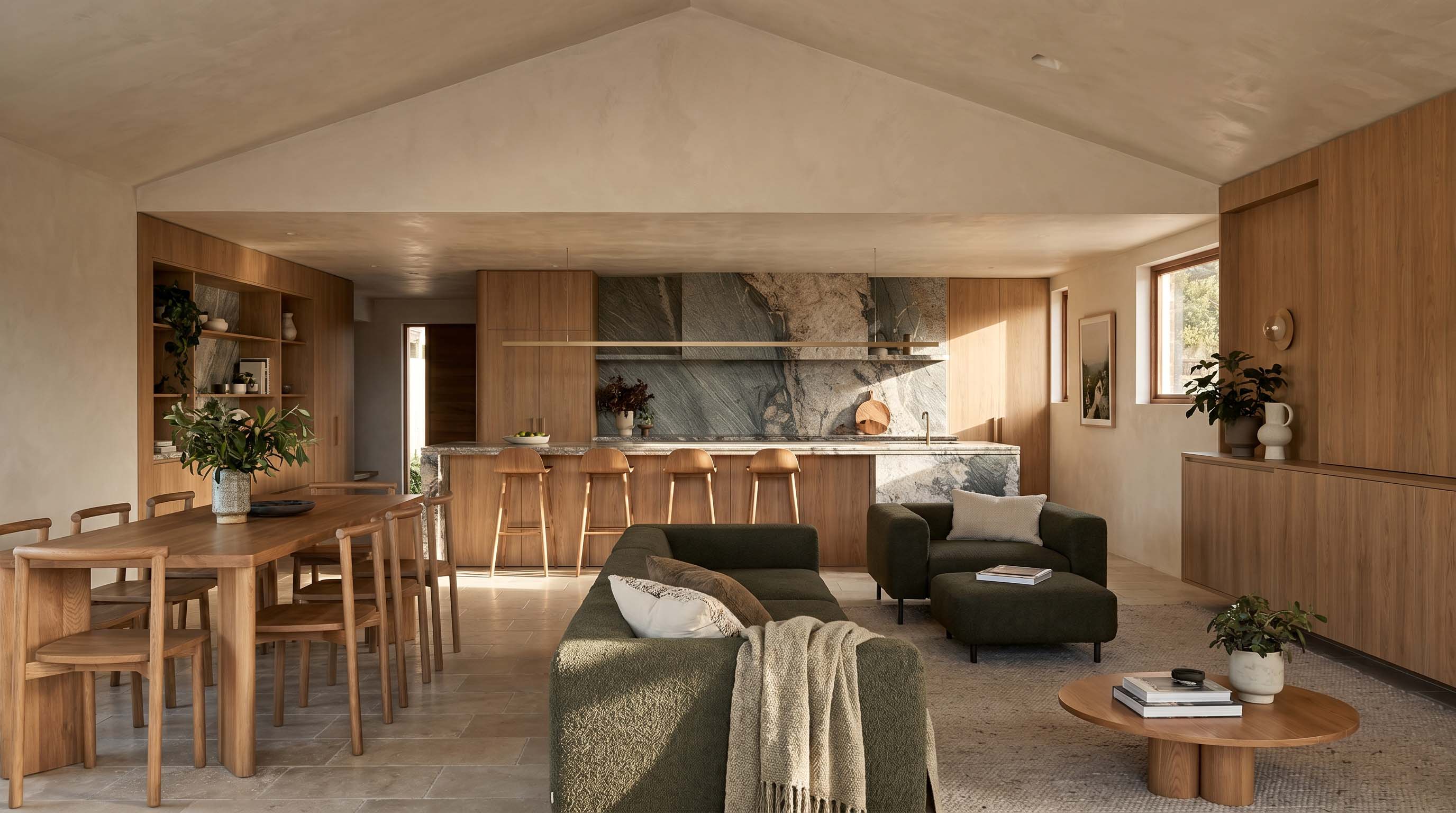 Open-plan kitchen, dining and living area under a raked ceiling