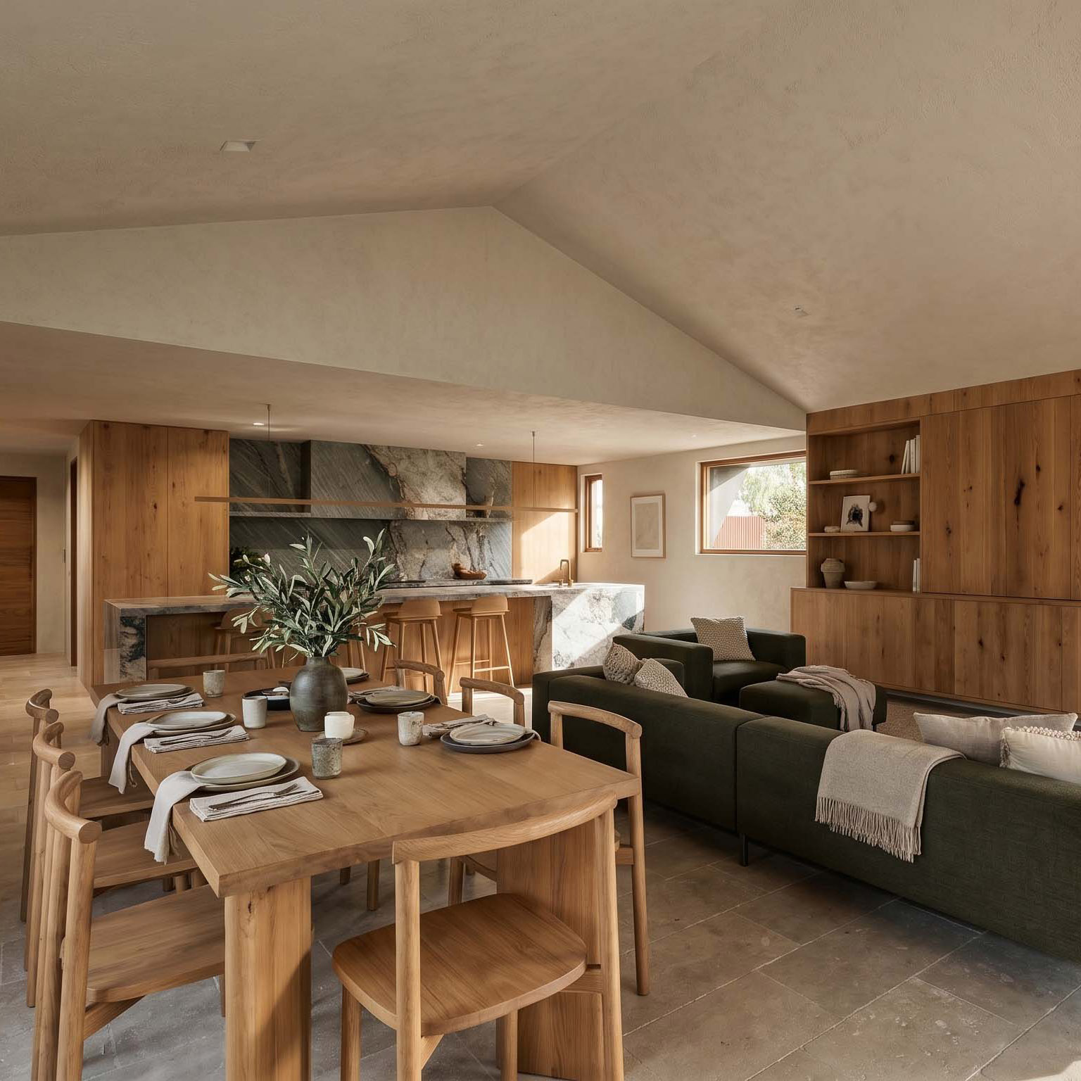 Dining and living area with timber joinery and a green sofa