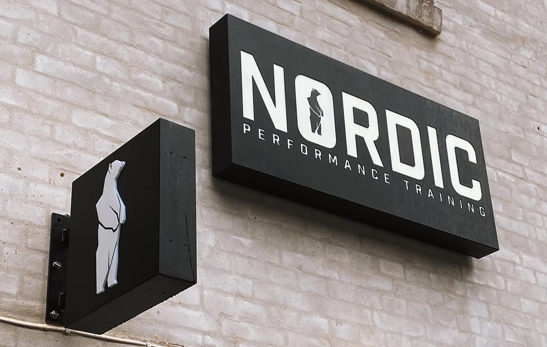 Nordic Performance Training signage with the logo displayed above the entrance to our private gym in Copenhagen.