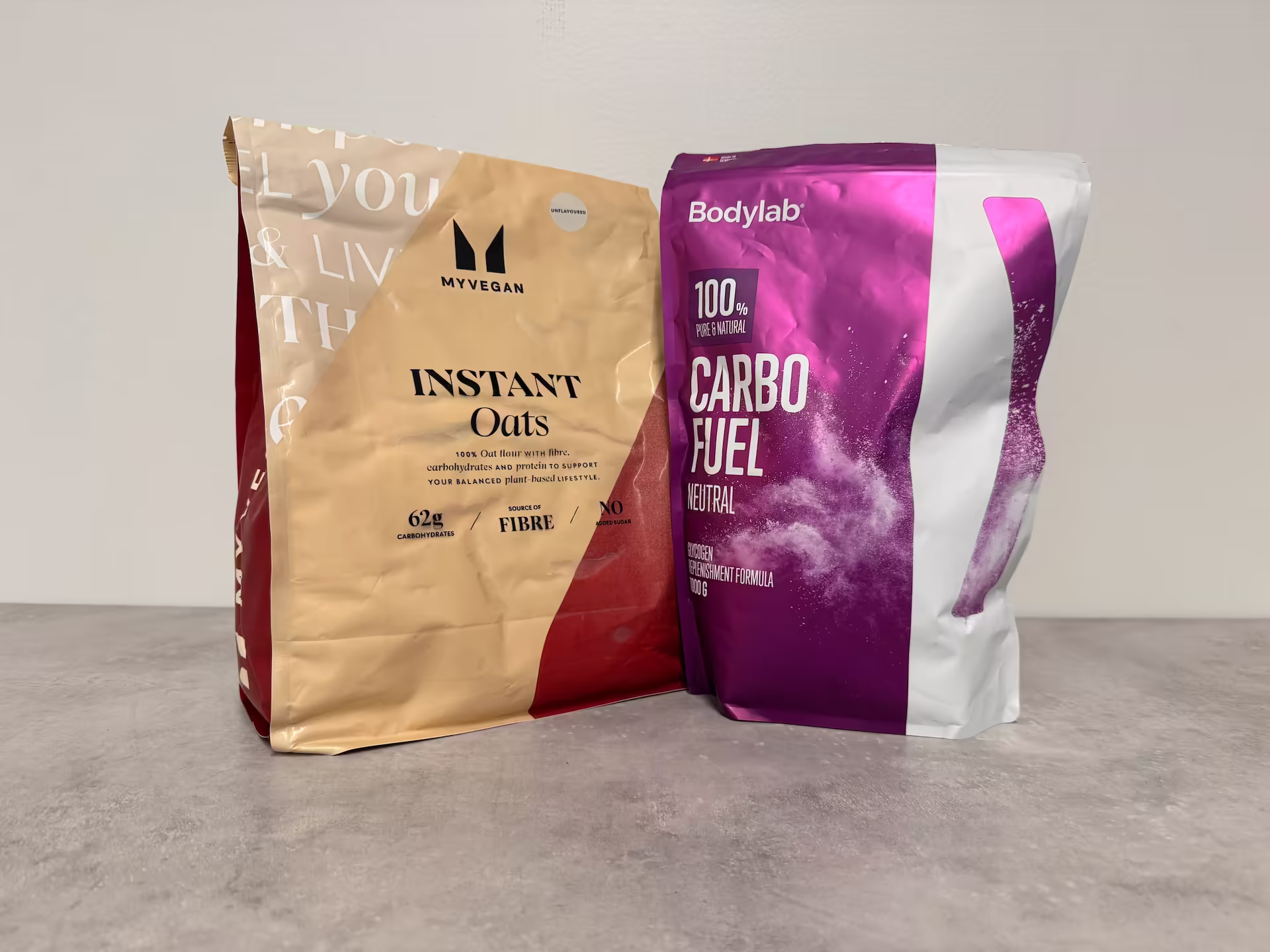 Image showing carbohydrate supplements — instant oats from MyProtein and dextrose from Bodylab — photographed at Nordic Performance Training’s private gym in Copenhagen.