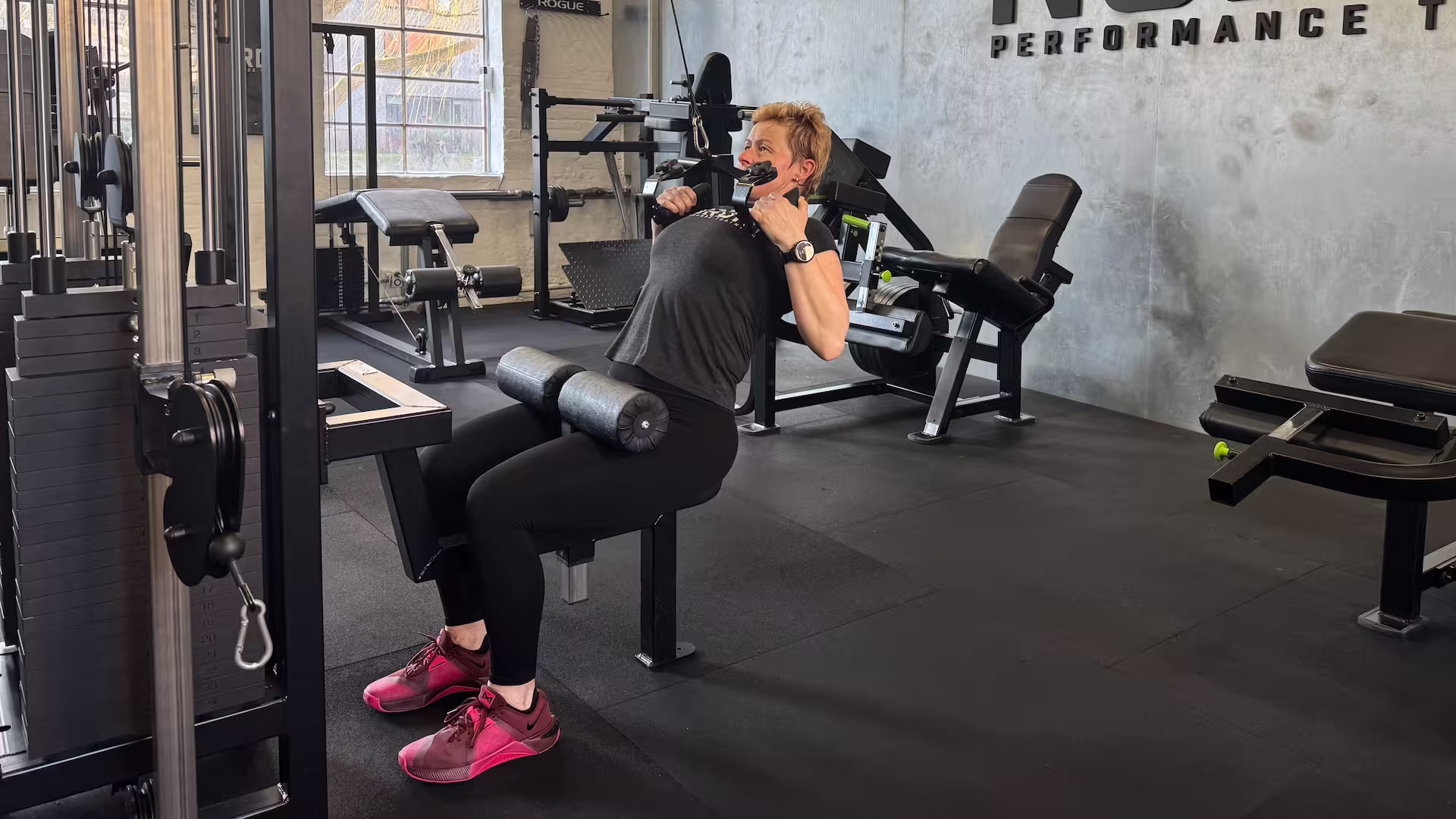 Client performs Cable Pulldowns during her personal training session at Nordic Performance Training.