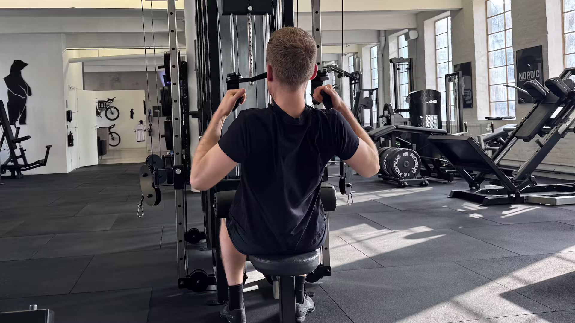 Client performing cable pulldowns during his personal training session at Nordic Performance Training in Copenhagen.