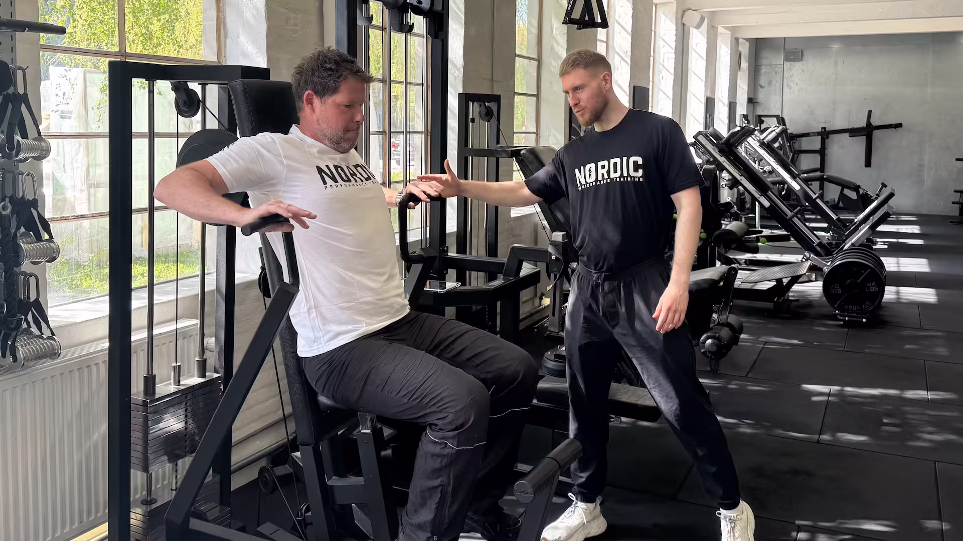 Our client Sebastian performing machine chest press during his rehab of a dislocated shoulder at Nordic Performance Training