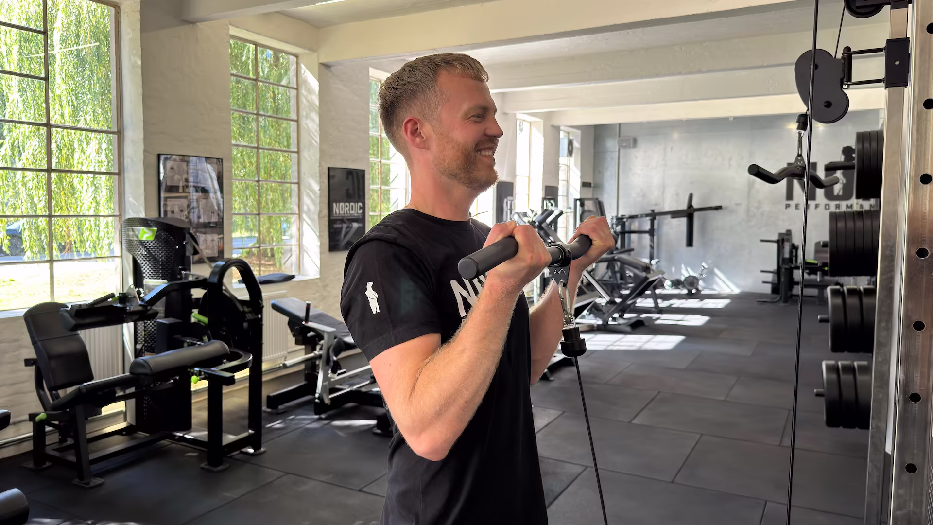 Jakob performing cable bicep curls as a finisher in his full body program.