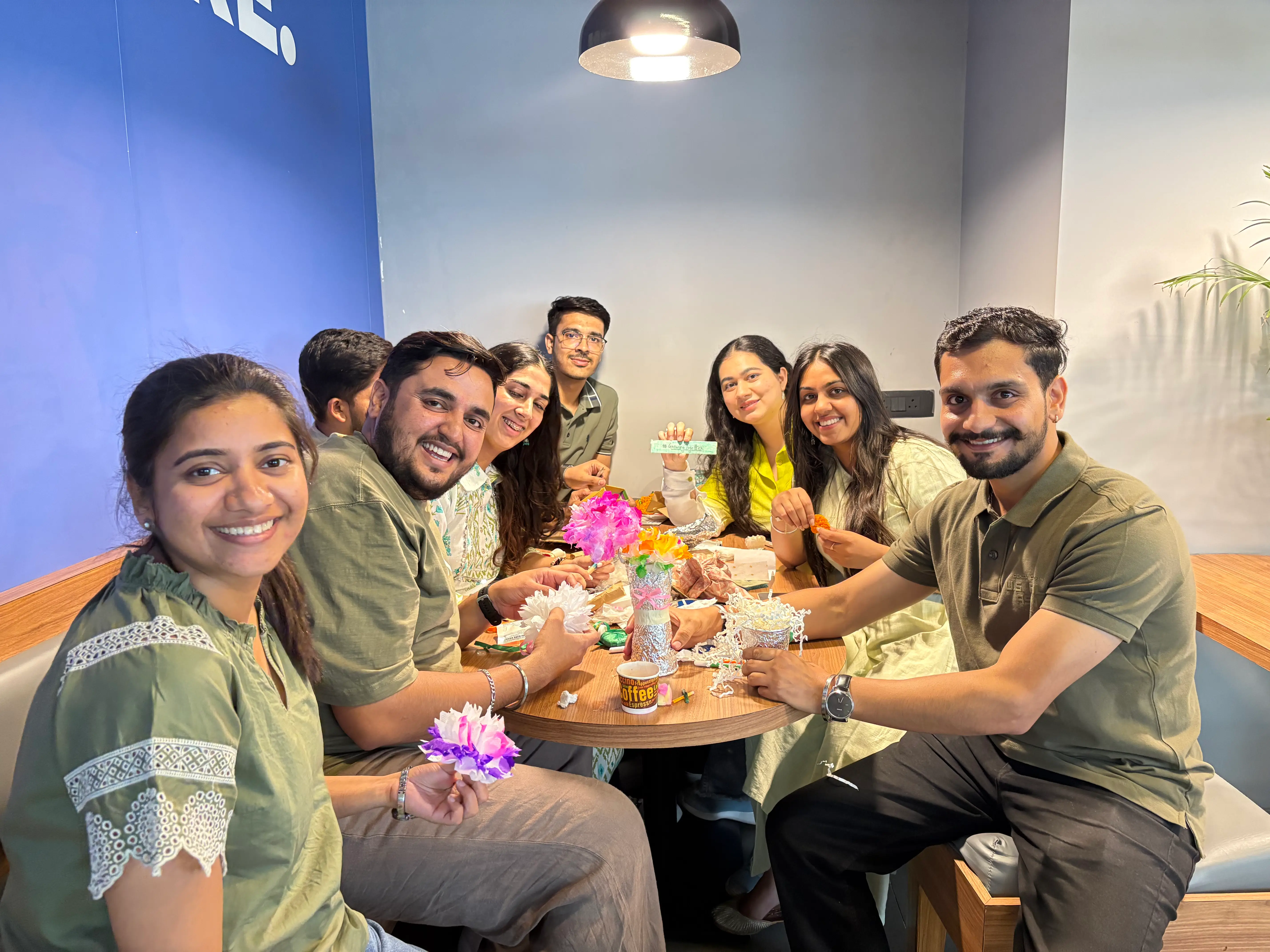 Team participating in a fun “Best from Waste” activity, creating decorative items from recycled materials while promoting sustainability and team bonding.