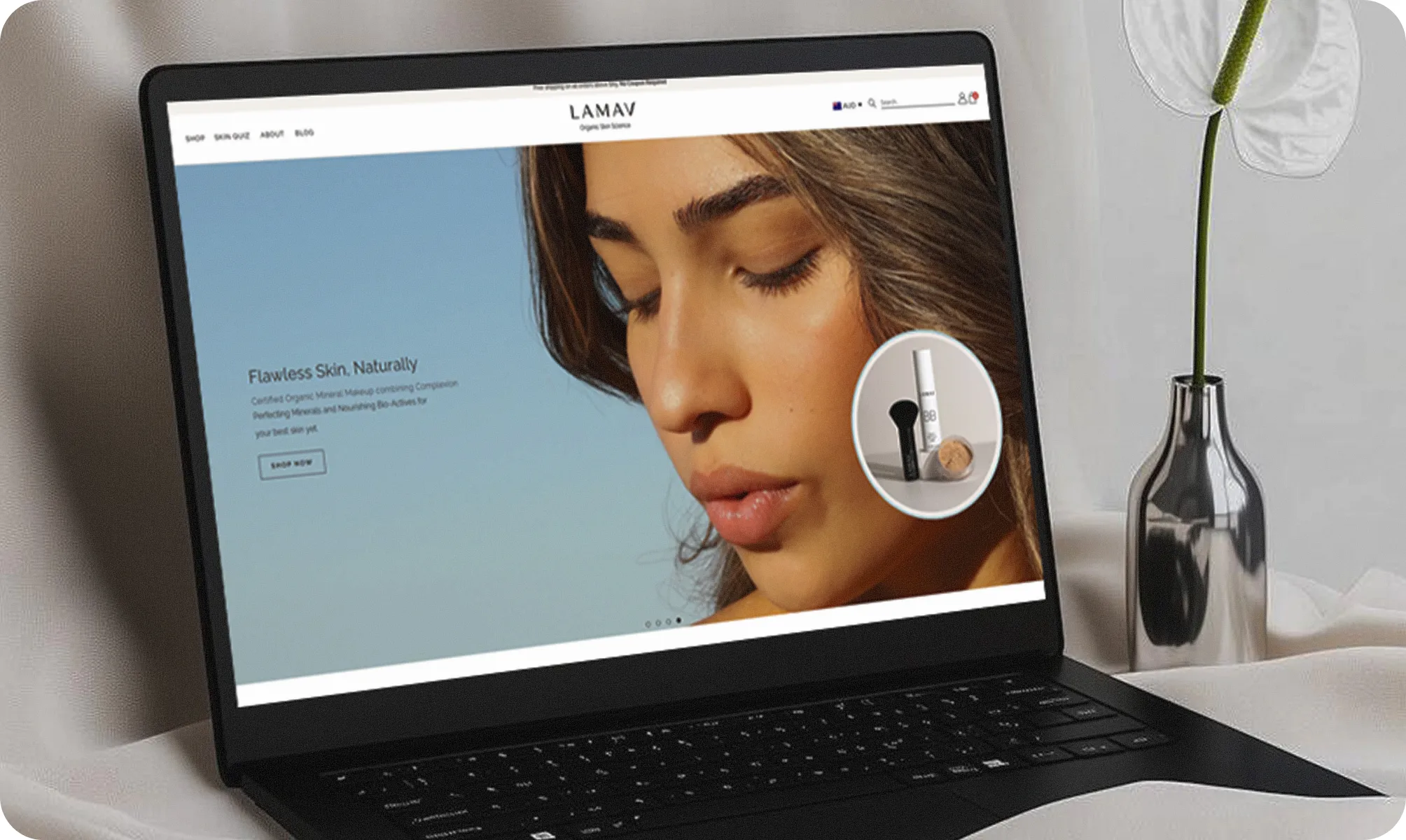Laptop screen displaying the LAMAV website homepage, featuring a close-up of a woman with flawless skin and a natural skincare product, emphasizing clean beauty branding.