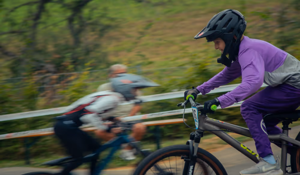 Mountainbiker im lila Outfit überholt auf dem Pumptrack beim Hessisch Pumptrack Series Event