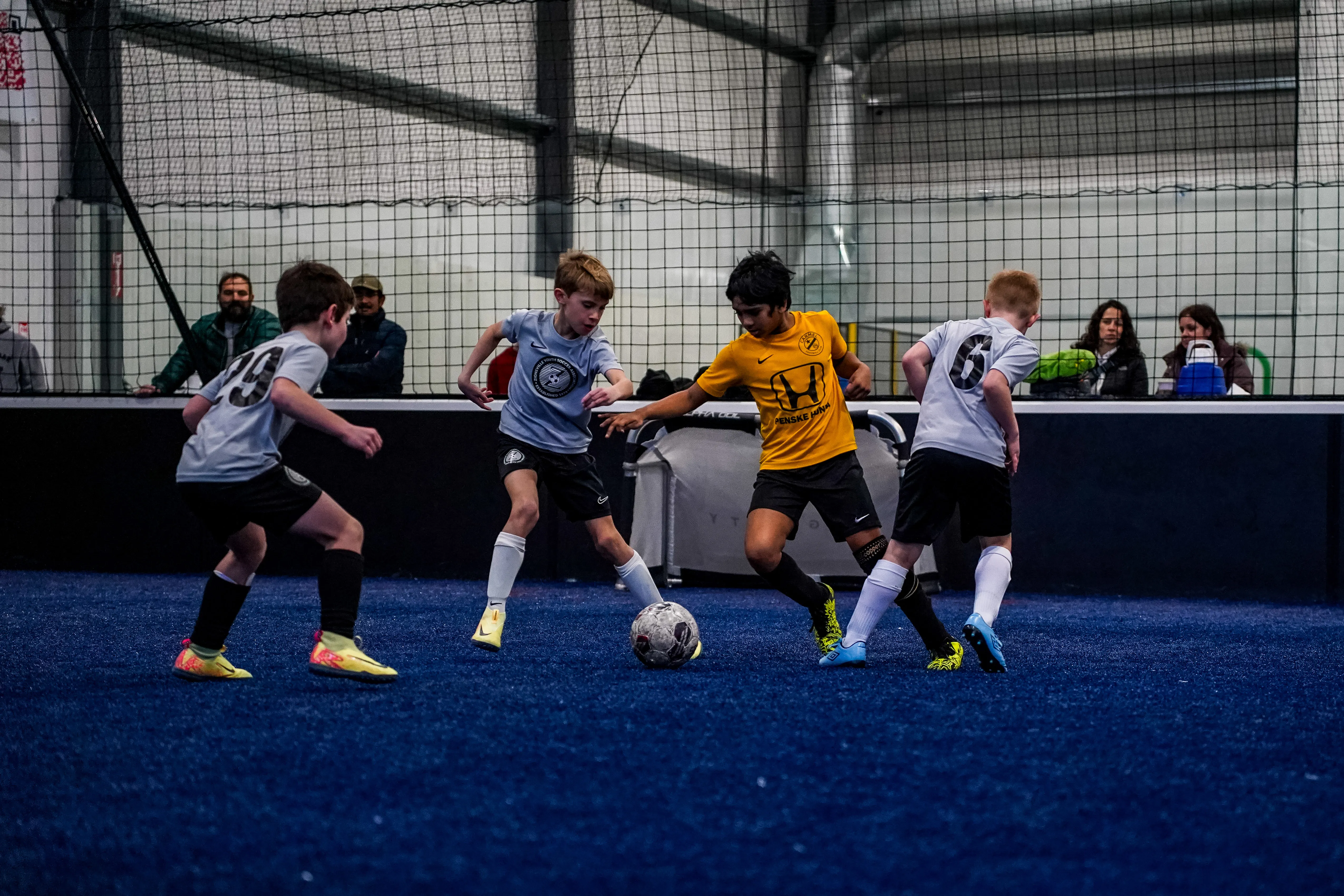 Youth soccer players during organized indoor competition at Sogility