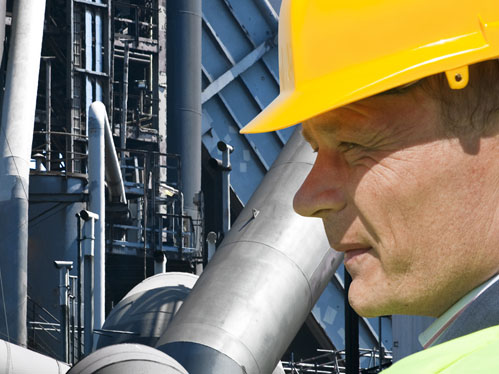 Industrial worker in hard hat at manufacturing facility
