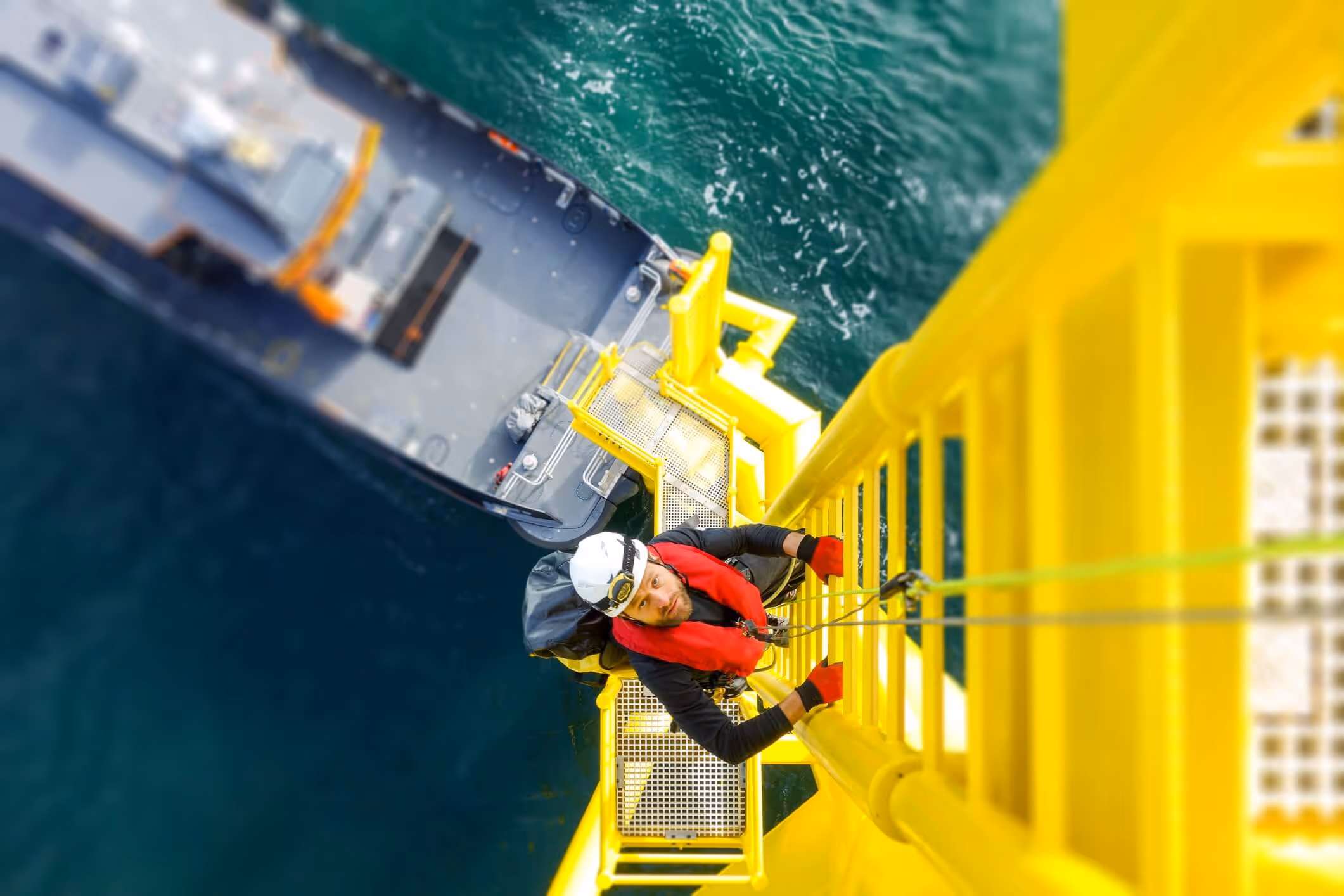 man climbing a ladder on a rig