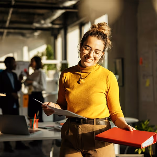 a lady in an office holding a folder