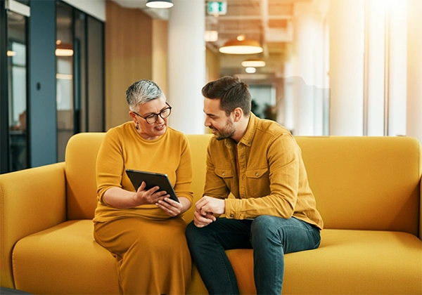 2 people looking at an iPad