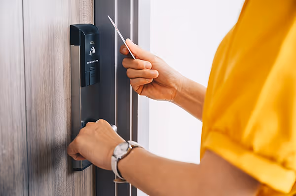 Someone entering a hotel room with a key card