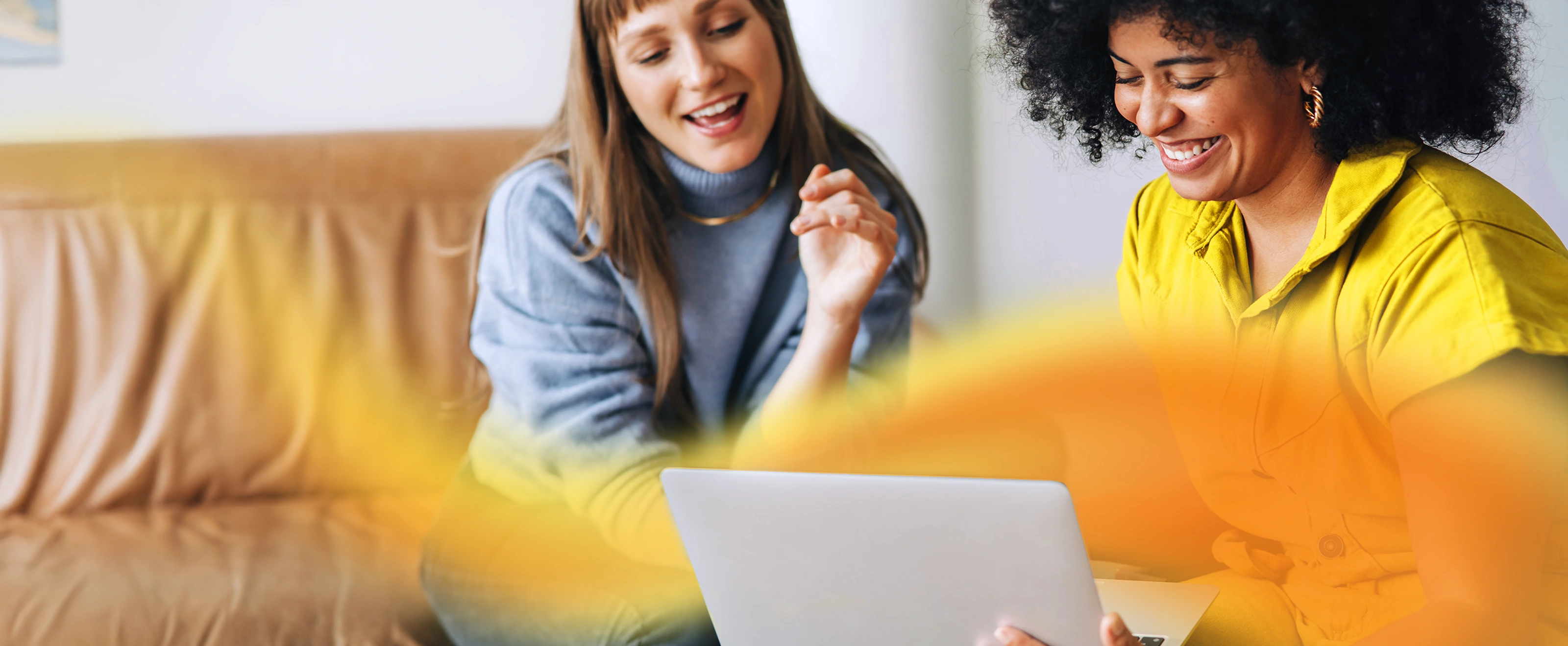 2 ladies working on a laptop