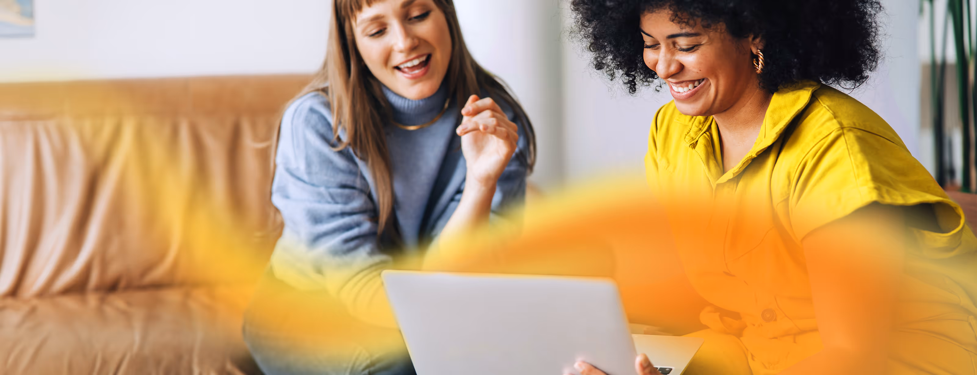 2 ladies working on a laptop