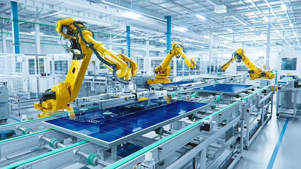 Yellow robotic arms working on a production line