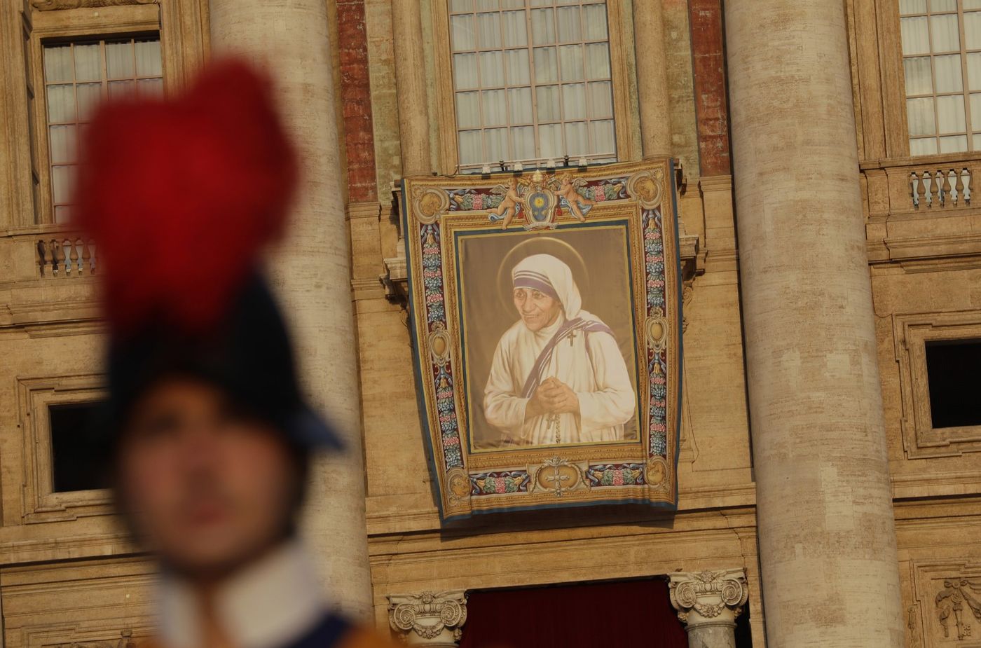 A tapestry showing Mother Teresa hangs from the facade of St Peter's Basilica (AP)
