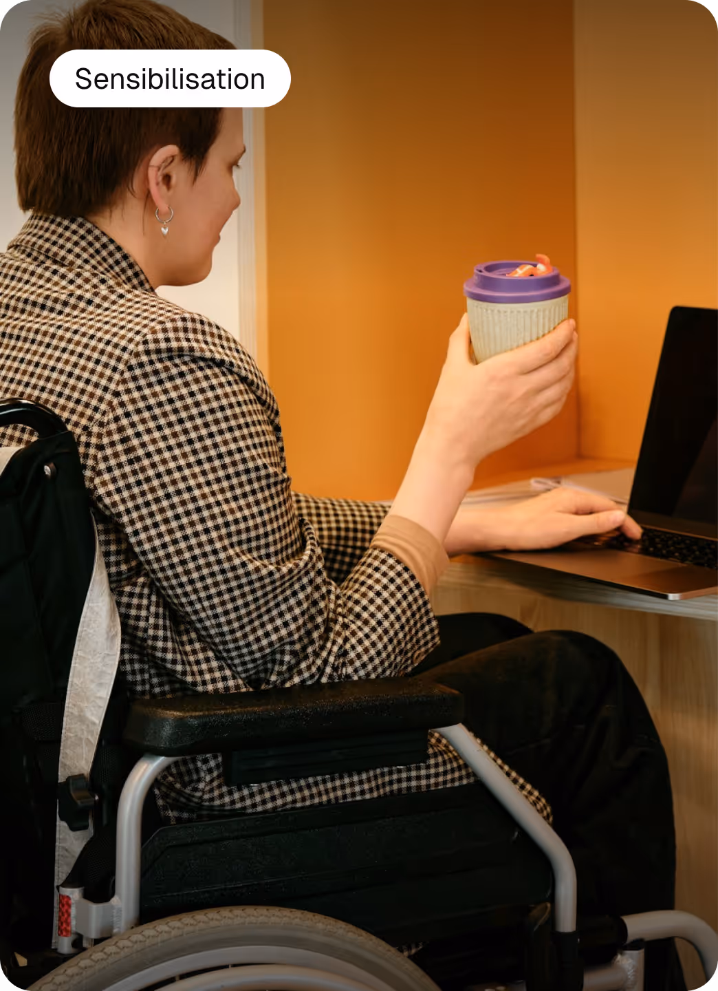 a woman in wheelchair holding a cup of coffee