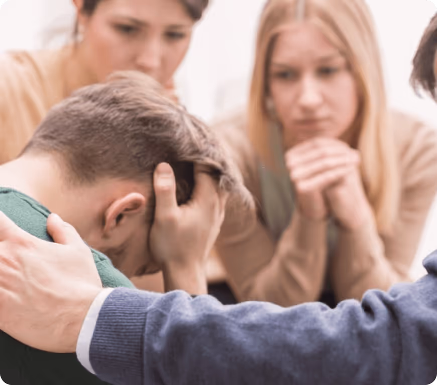 a group of people holding hands to a man's head