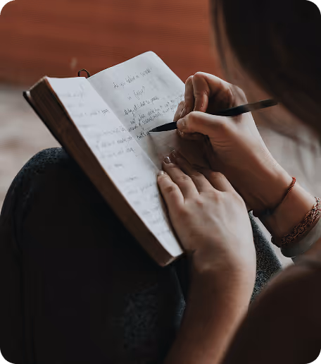 a person writing in a book