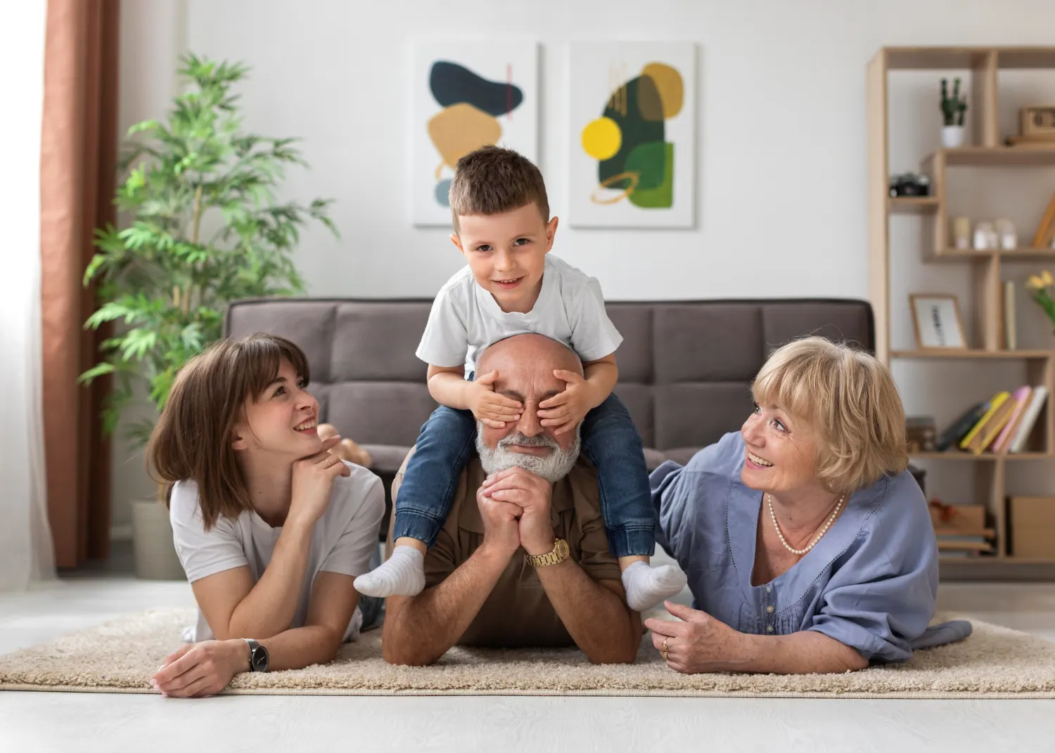 Happy multi-generation family playing on the floor