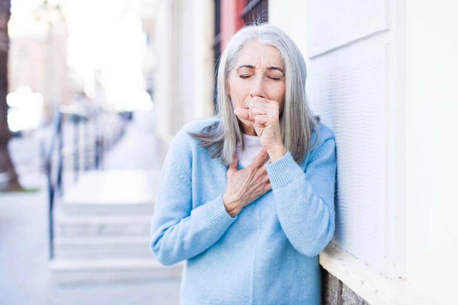 Elderly woman showing signs of respiratory strain