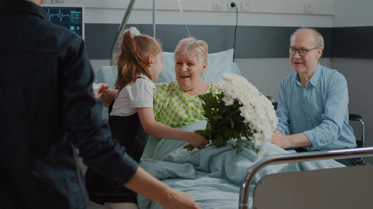 Family visiting senior patient in hospital bed