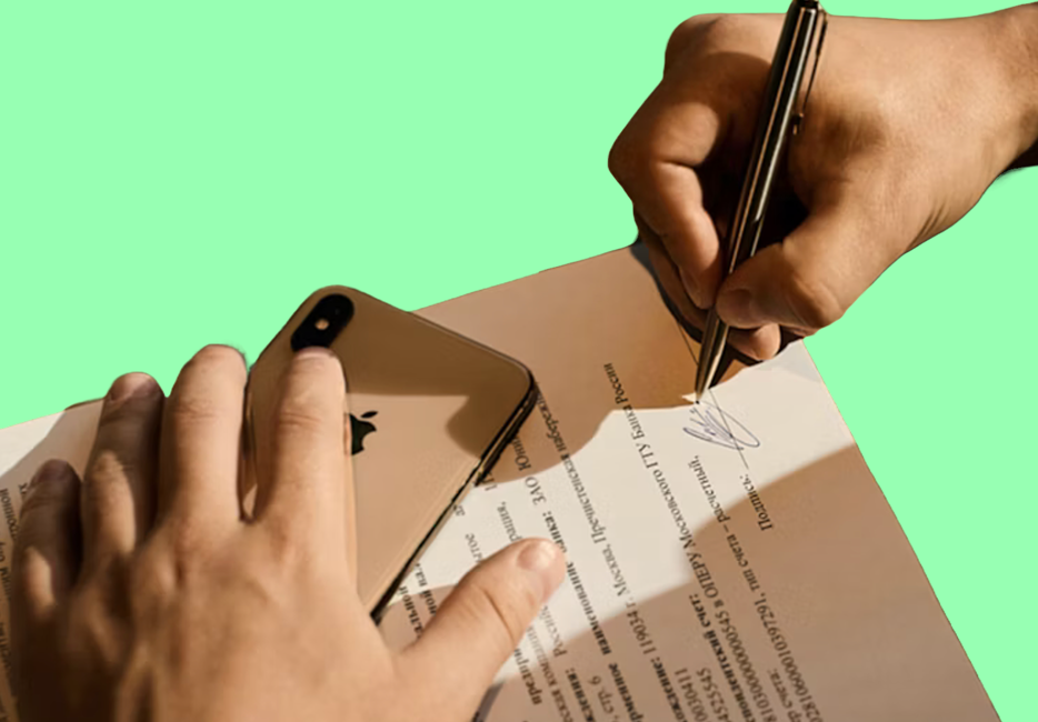 Person signing a document with a wet signature