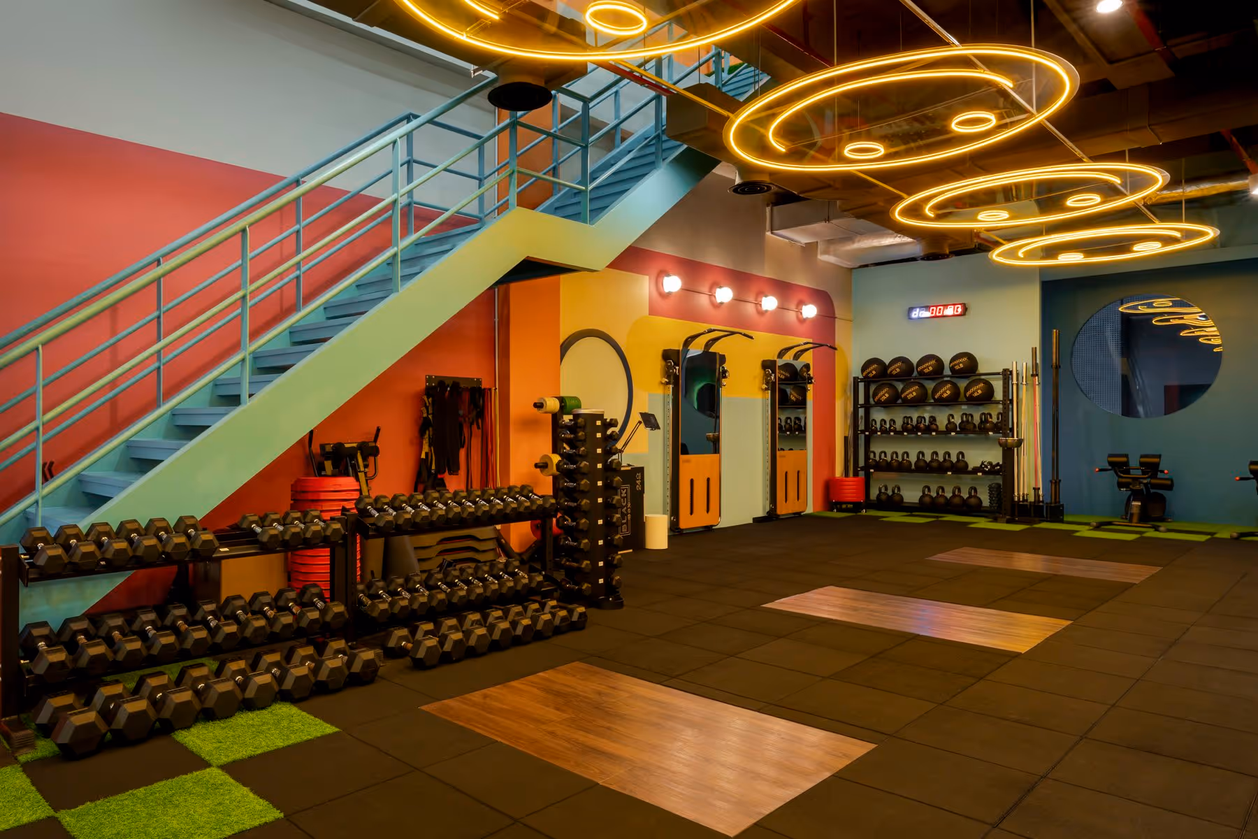 Wide shot of Good Juju Barbell Club’s open gym space with natural light and strength equipment