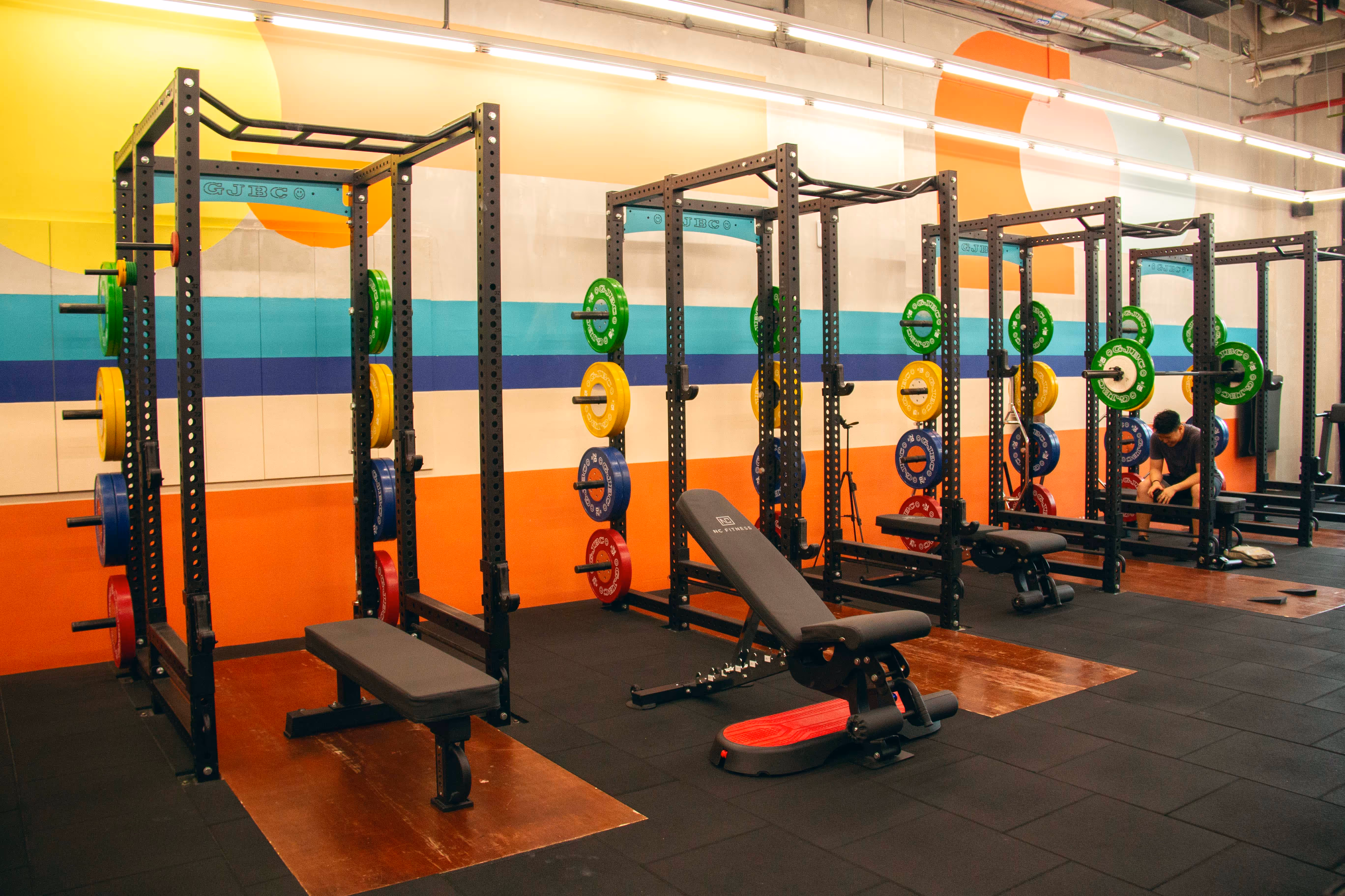 Interior of the gym showcasing weights, racks, and training zones