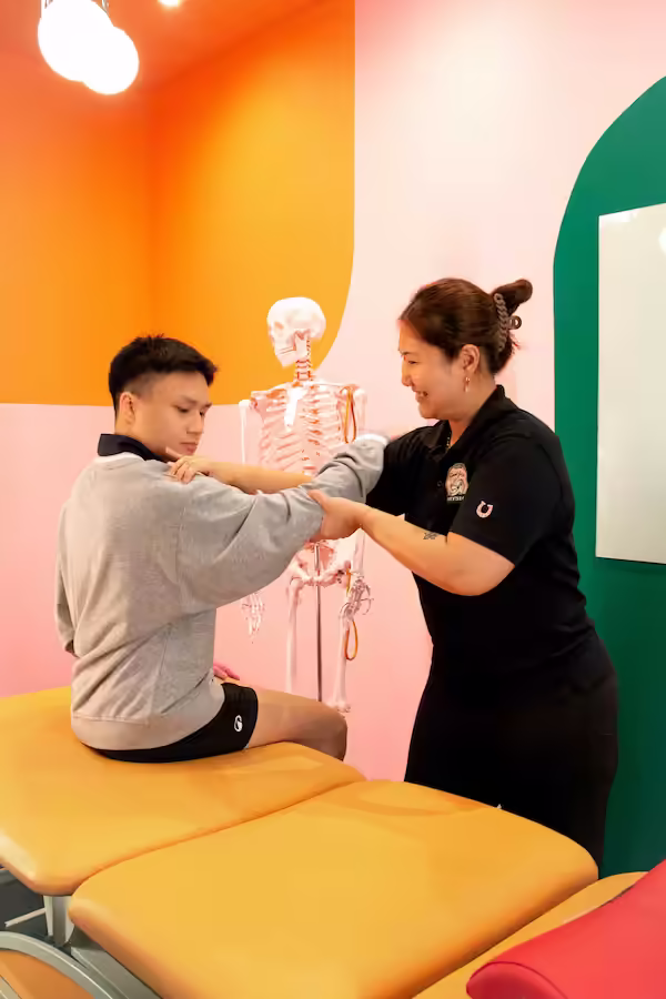 one of our Good Juju physiotherapists guiding and educating a client through a movement